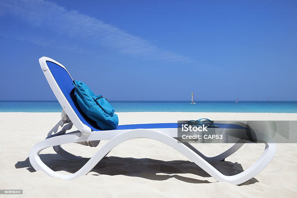 Reserved Beach Chair At The Ocean "Reserved beach chair with sac-pack on tropical beach, Caribbean Sea, Cayo Santa Maria, Cuba." Beach Stock Photo