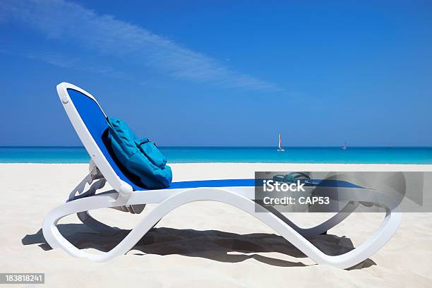 Reserved Beach Chair At The Ocean Stock Photo - Download Image Now - Beach, Backpack, Blue