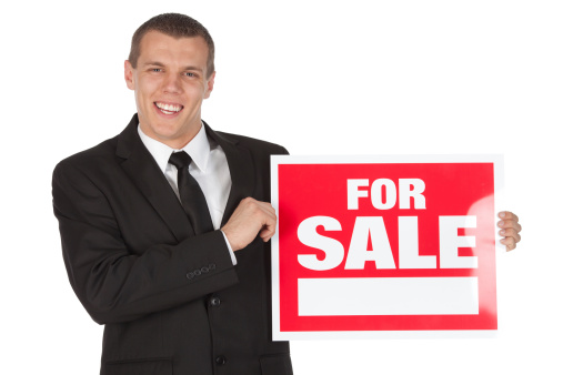 Businessman holding a 'For Sale' signhttp://www.twodozendesign.info/i/1.png