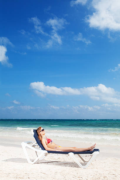 istock Young sexy woman sunbathing on beach 183819154