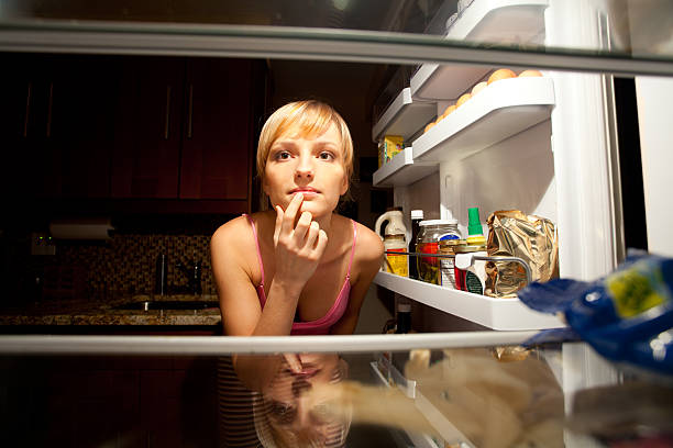istock Woman thinking about her food choice inside refregirator 183819239