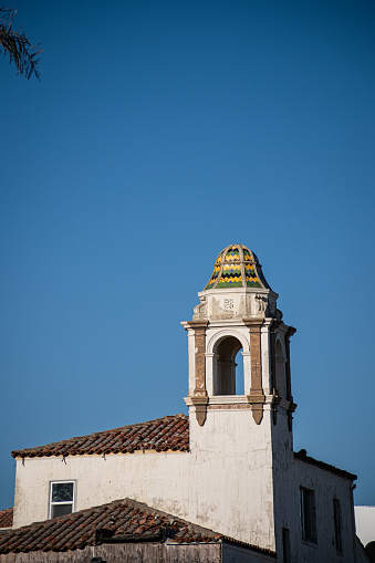 A colorful cupola on a bell tower near the beach in Santa Cruz.