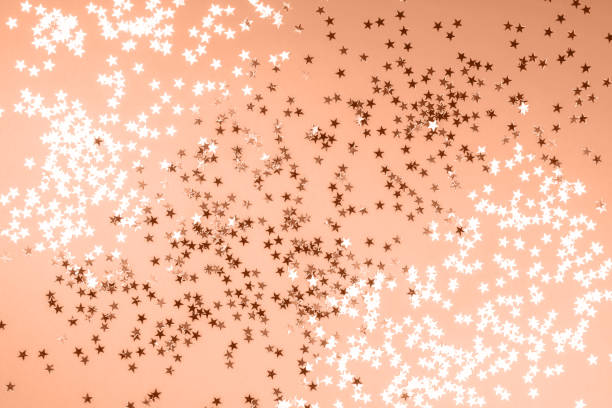 istock Beautiful orange background with silver glitter stars 1838199422