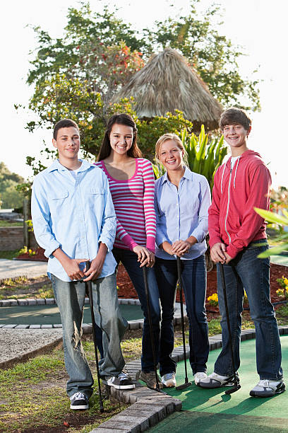 istock Teenagers playing miniature golf 183820196
