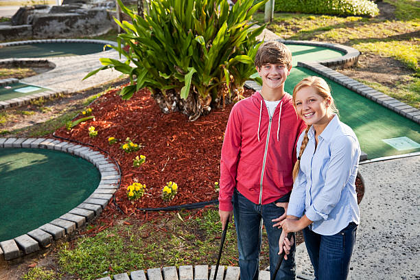 istock Teenage couple playing miniature golf 183820198