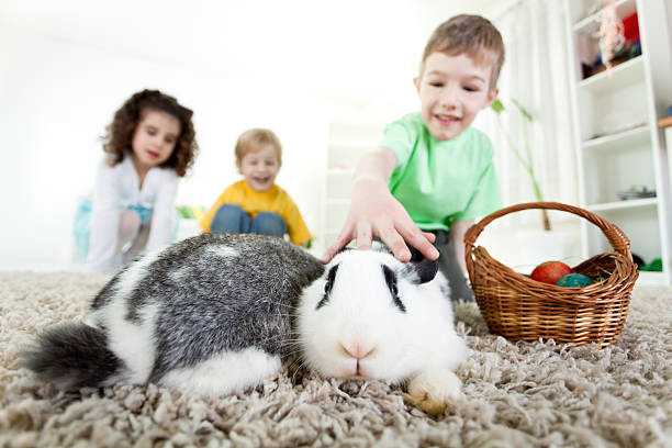 istock Little children playing with Easter bunnies 183820266