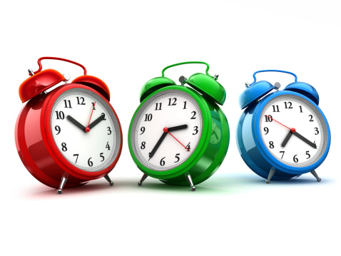 Red, green and blue alarm clocks. Isolated on white, 3d render.