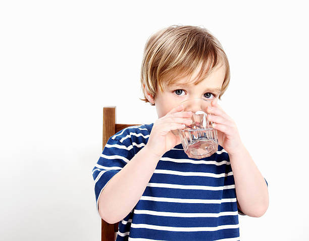 istock Small child enjoying a drink of water 183821280