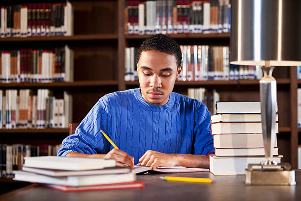 istock African American teenager studying in library 183821303