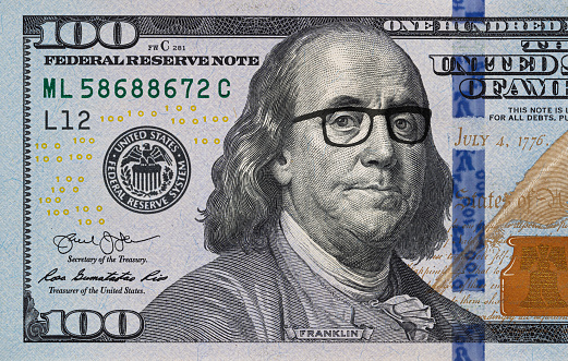 Benjamin Franklin in glasses on US 100 dollar banknote for design purpose