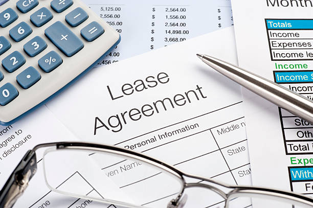 Lease Agreement Form with pen, calculator stock photo