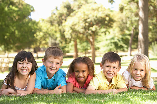 istock Group Of Children Laying In Park 183821706
