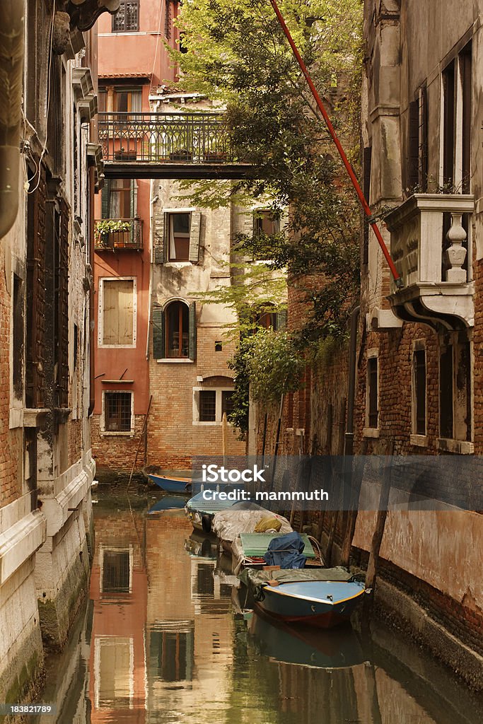 motorboats on a venetian canal "motorboats on a canal in Venice, wonderful reflections on the water" Bridge - Built Structure Stock Photo