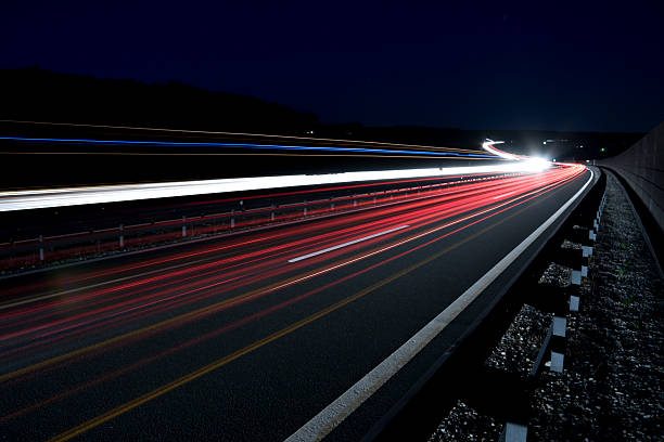 istock Bright light trails on the road in the dark 183821807
