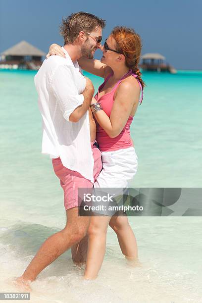 Flirting Young Couple In Turquoise Lagoon Stock Photo - Download Image Now - Adult, Adults Only, Beach