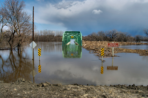 View of a flooded bridge along the Red River.  Photograph taken from clay dike.
