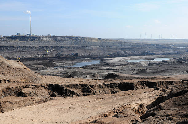 istock open Strip Coal mine with smoke stake fumes 183822849