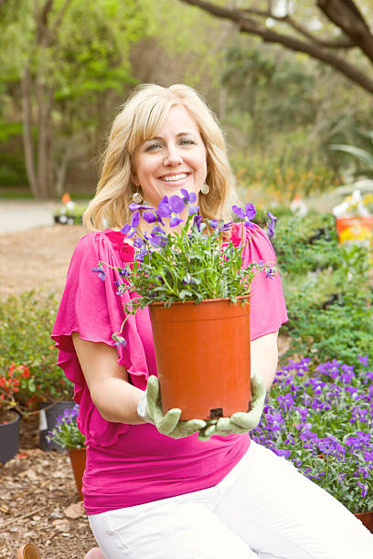 istock Gardener women smiling with plant 183823026