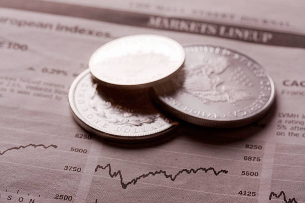 istock dollar coins on financial newspaper 183823190