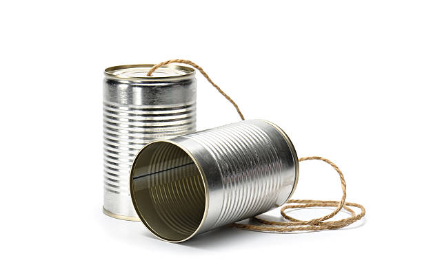 Can Phone "Two tin cans connected by string on white background, suggesting primitive, simplest form of communication." string telephone stock pictures, royalty-free photos & images