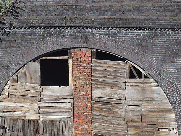 istock Roughly boarded derelict railway arch 183823935
