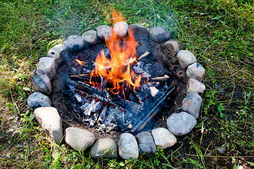 A daytime campfire in the summer.