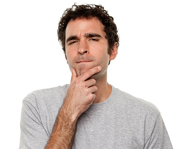 Man holding his chin in a deep-in-thought expression Portrait of a man on a white background. http://s3.amazonaws.com/drbimages/m/doncam.jpg frowning headshot close up studio shot stock pictures, royalty-free photos & images