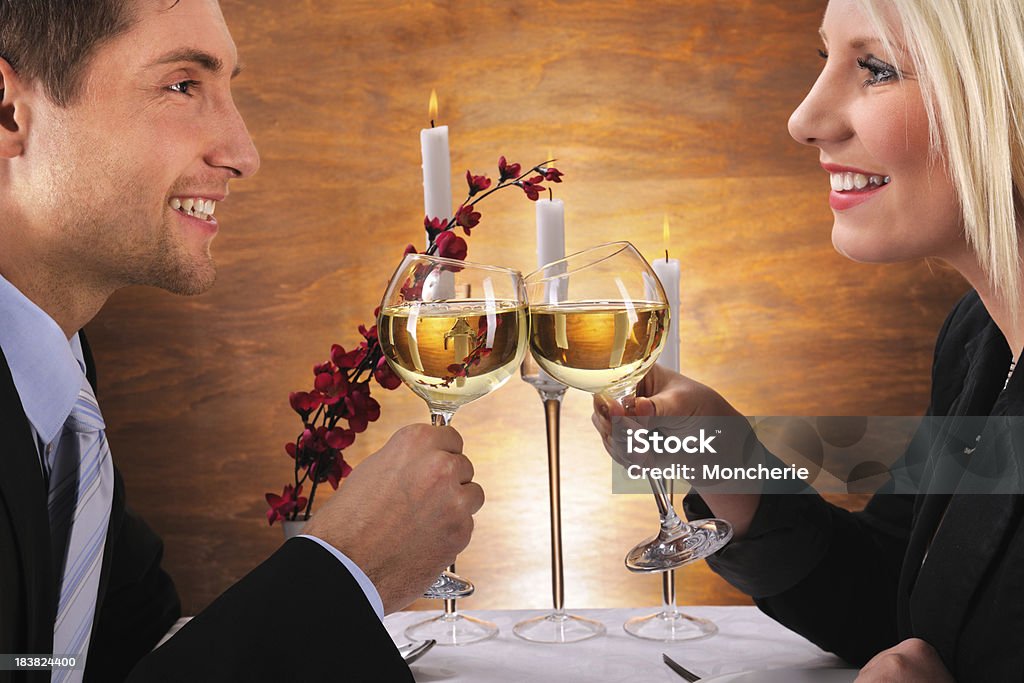Romantic dinner Young couple hitting the wine glasses. XXXL image Adult Stock Photo