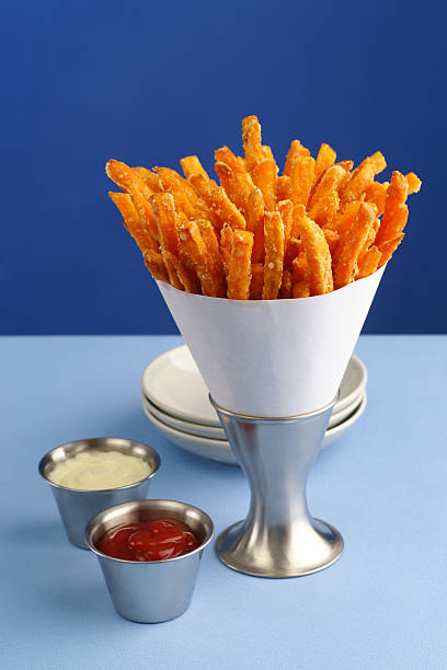 Sweet Potato Fries Still life of freshly made sweet potato fries with catsup and aioli. sweet potato french fries stock pictures, royalty-free photos & images