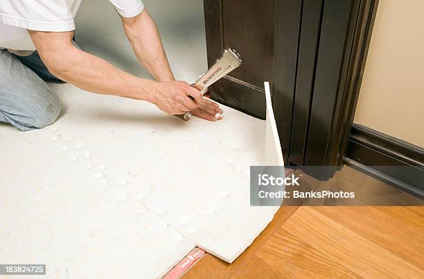 Carpet Installer Stapling Pad To Subfloor Stock Photo - Download Image Now - Carpet - Decor, Padding, Installing