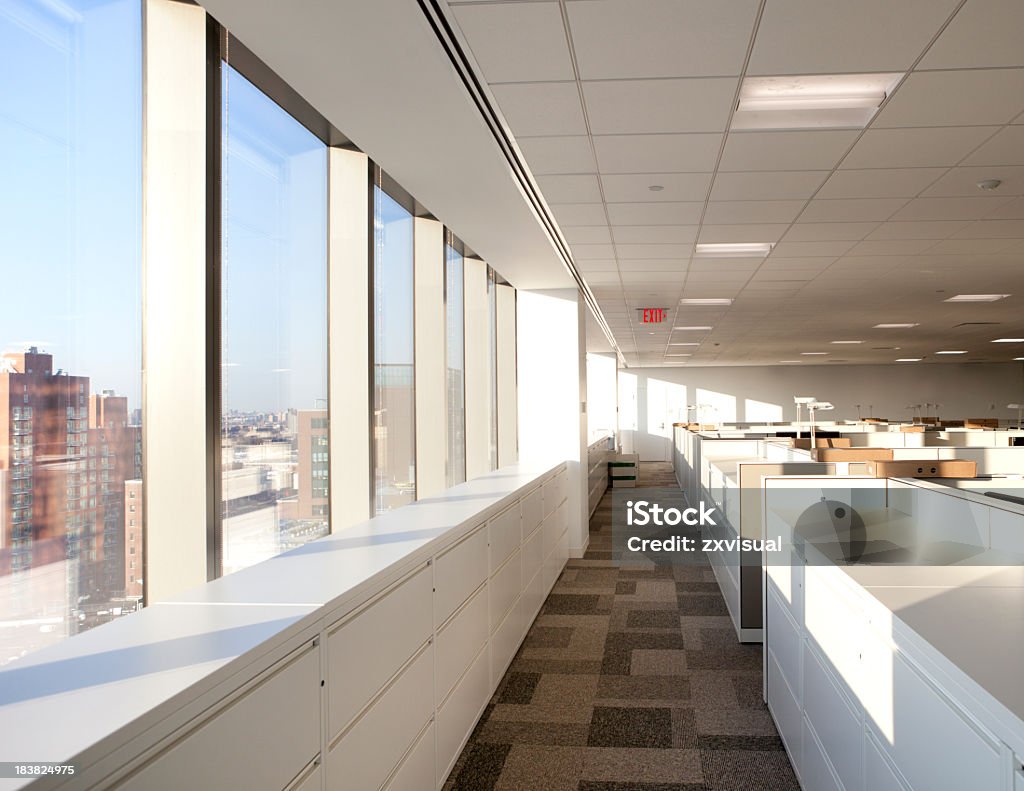 Modern office Space Walkway path in a modern office space illuminated with natural sunlight through the windows.  Office Stock Photo