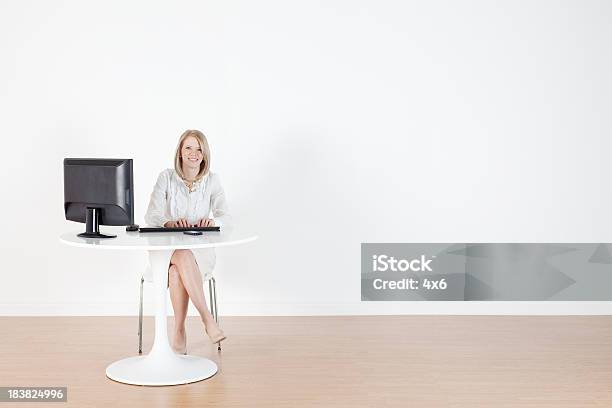 Businesswoman Working On A Computer Stock Photo - Download Image Now - Desk, Sitting, Cut Out