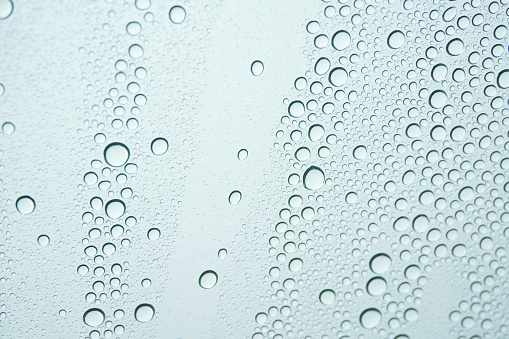 close up view of window glass with water drops