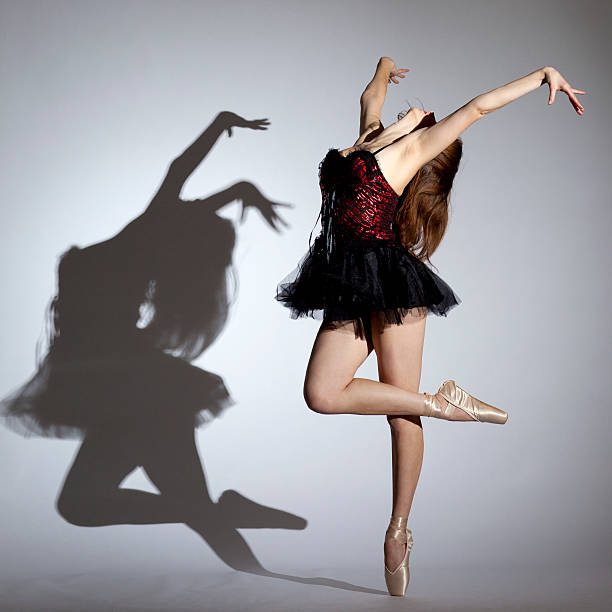 istock Young ballerina dancing on gray background 183825616
