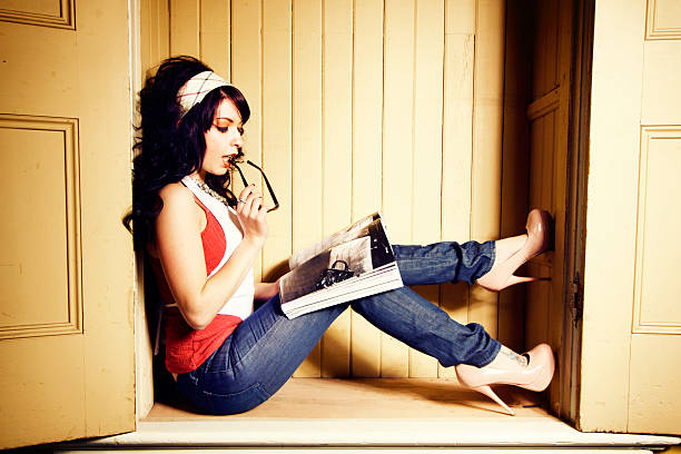 A beautiful dark haired woman in a closet.