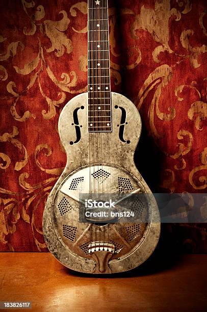 Gold Acoustic Guitar With Red Floral Wallpaper Stock Photo - Download Image Now - Arts Culture and Entertainment, Blues Music, Celebration Event