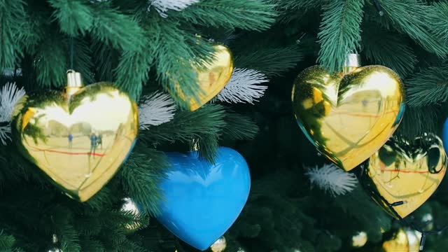 Christmas tree with heart shaped decor in the blue and yellow colors Ukraine