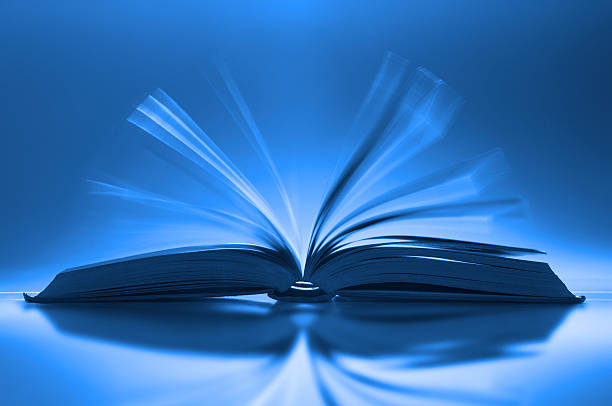 istock Book fanned open on desk with motion blur between pages 183827849