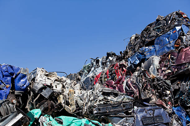 istock Blue sky over old greasy car parts on junkyard 183827858