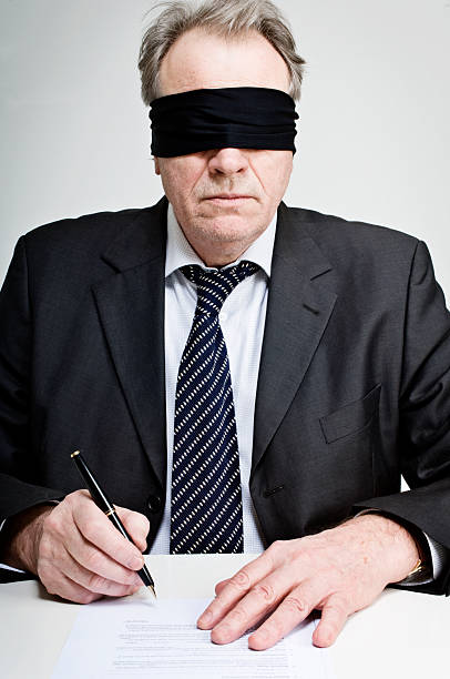 Gagged and Blindfolded Businessman Signing A Contract  interroagtion stock pictures, royalty-free photos & images