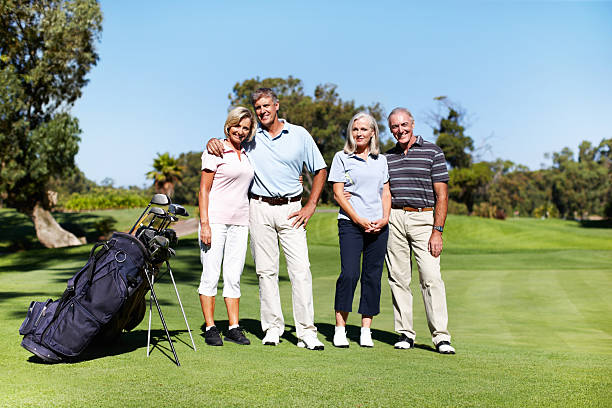 istock Two couples of golfers posing on a golf course 183828297