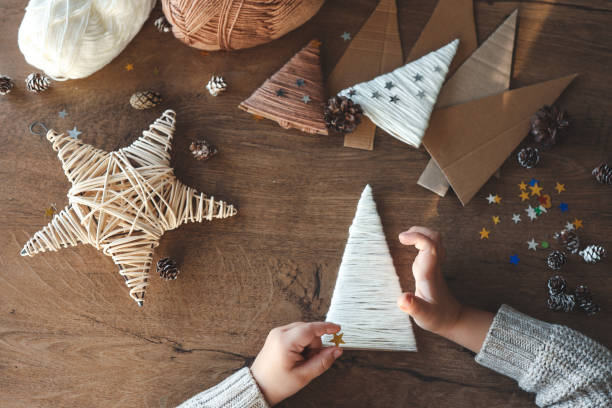 istock Child makes Christmas decoration from yarn 1838291020
