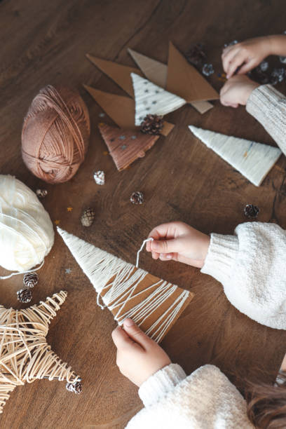 istock Child makes Christmas decoration from yarn 1838291039