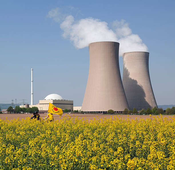 istock Protest at Nuclear power station with cooling towers behind canola 183829319