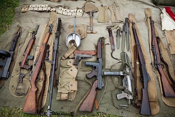 "A collection of weapons from the Second World War, including rifles, pistols and machine-guns."