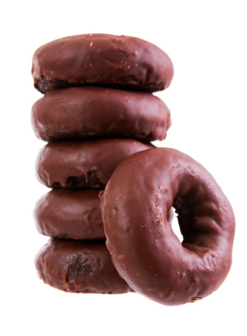 Stock photo of a stack of chocolate doughnuts isolated on a white background.