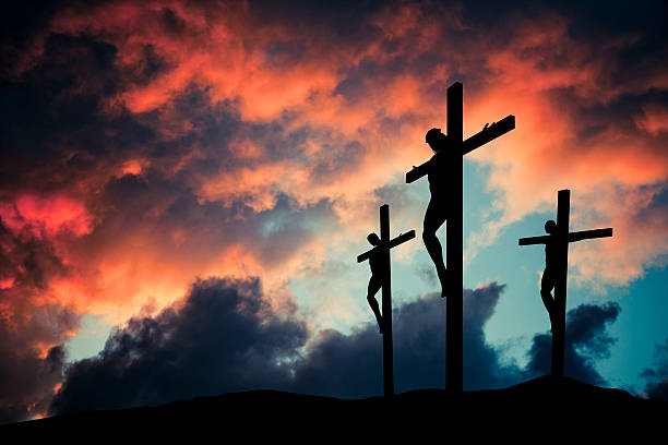 Christian Jesus Christ son of god crusified on wooden cross Crucified Jesus Christ over gloomy skies.More religious images: cross-shape stock pictures, royalty-free photos & images