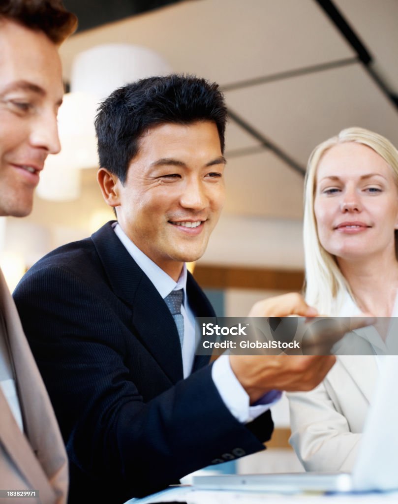Executives in a business meeting Portrait of three cheerful executives in a business meeting Business Stock Photo