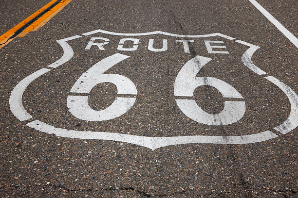 istock Route 66 Sign Painted on Empty Road 183829994