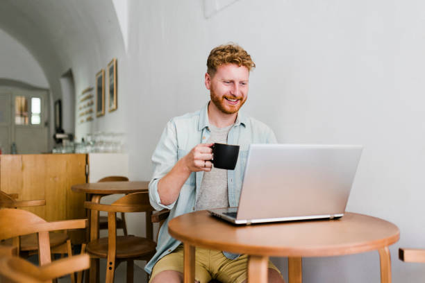istock Attractive mature man sitting in coffee shop and using laptop 1838303039